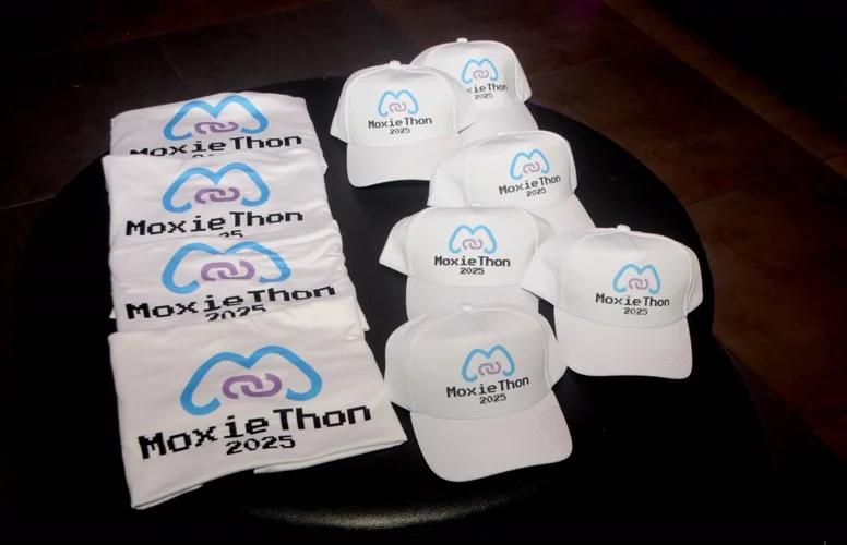Moxiethon 2025 shirts and caps, laid out for arriving participants.