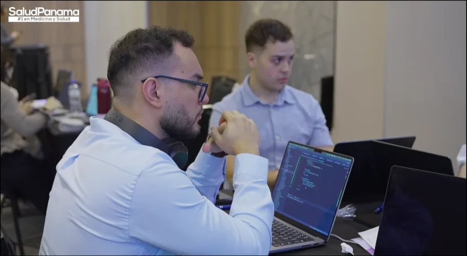 A participant looks over a line of code on his laptop.