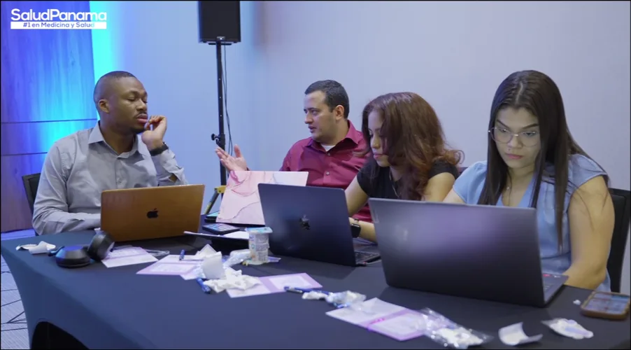 A team of four discusses their project around a shared table.