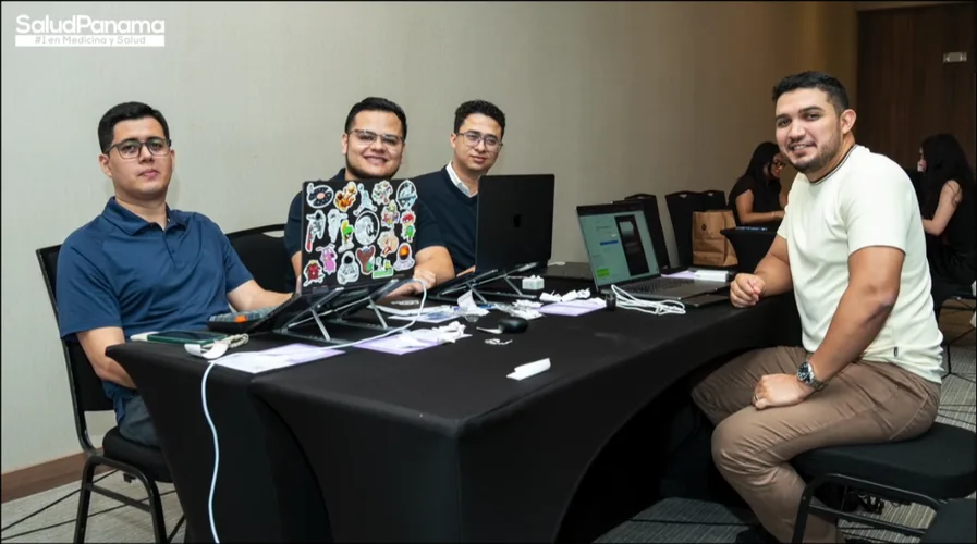 A team of four works together at their table.