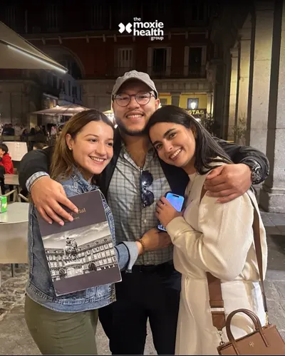Three colleagues enjoy dinner together in Madrid.