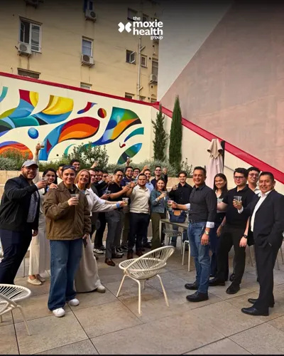 The Moxie Health Group team gathers for a toast in Spain.