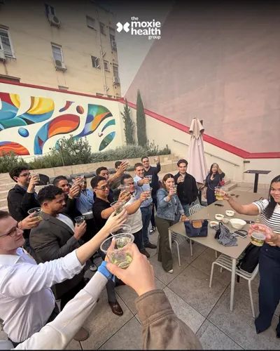 The team raises a glass together on the terrace.